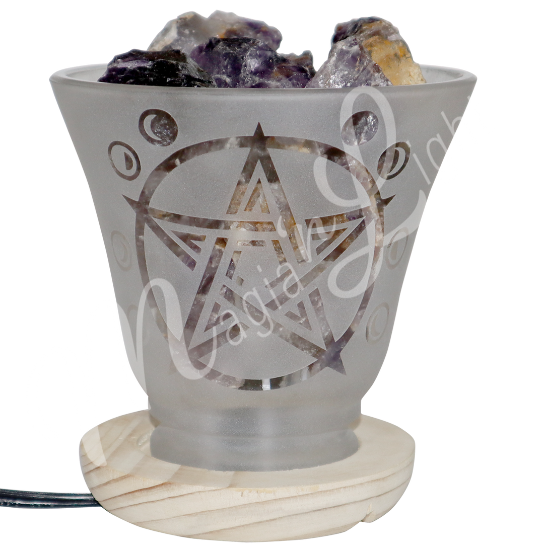 Decorative frosted glass lamp with etched pentacle design, wooden base, and filled with amethyst crystals.