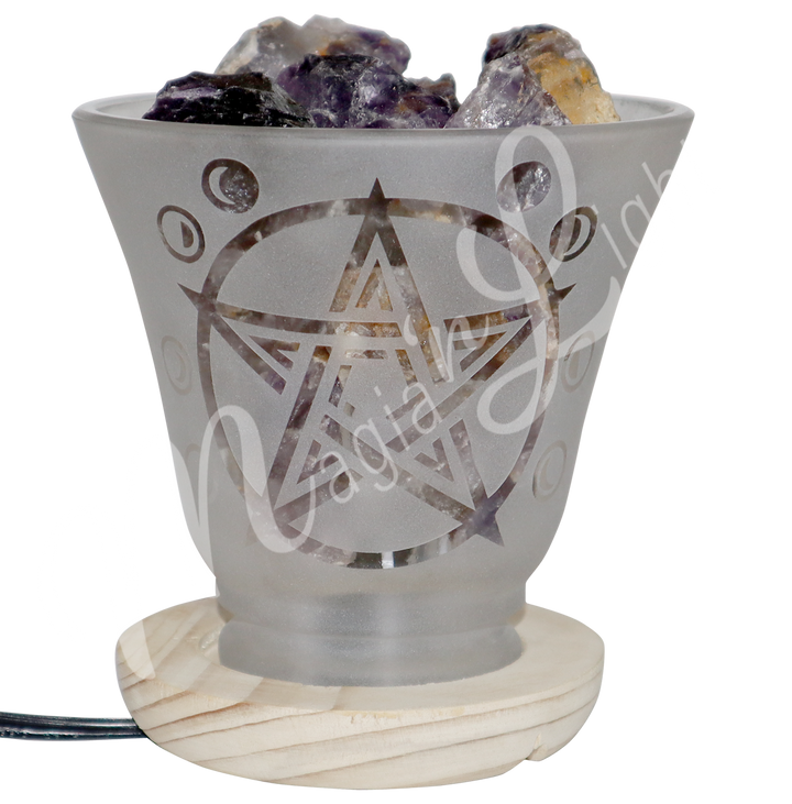 Decorative frosted glass lamp with etched pentacle design, wooden base, and filled with amethyst crystals.