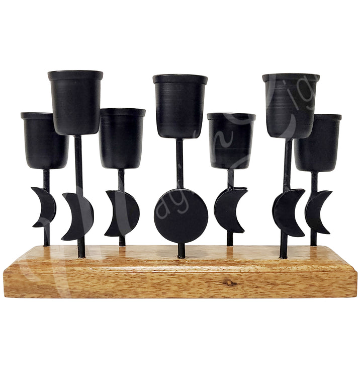 An iron moon phase mini candle holder on wooden base, designed to hold seven candles.