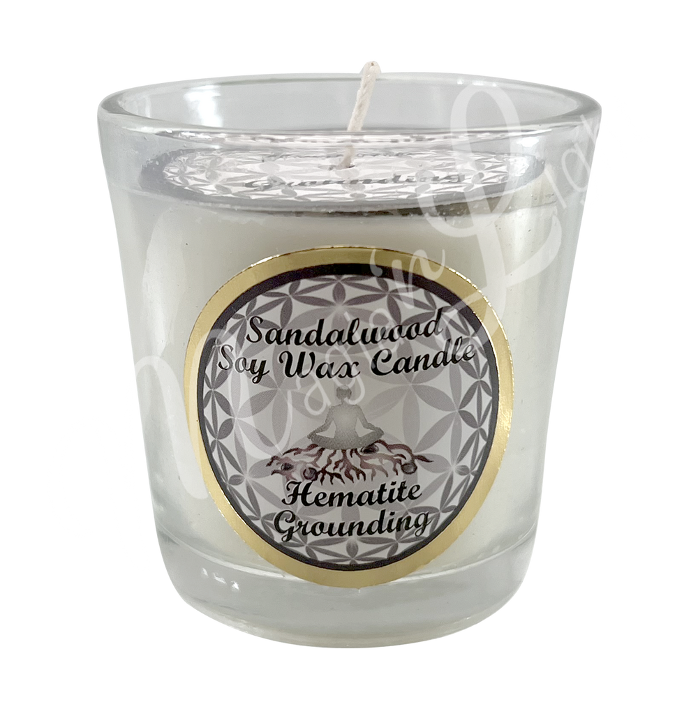 White soy wax candle in a glass holder, labeled "Sandalwood Soy Wax Candle – Hematite, Grounding.