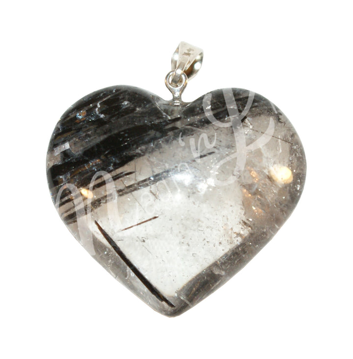 A heart-shaped pendant made of rutilated quartz with a metallic ring on top.