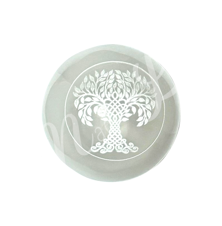 A clear glass sphere with a tree of life symbol engraved and painted white.