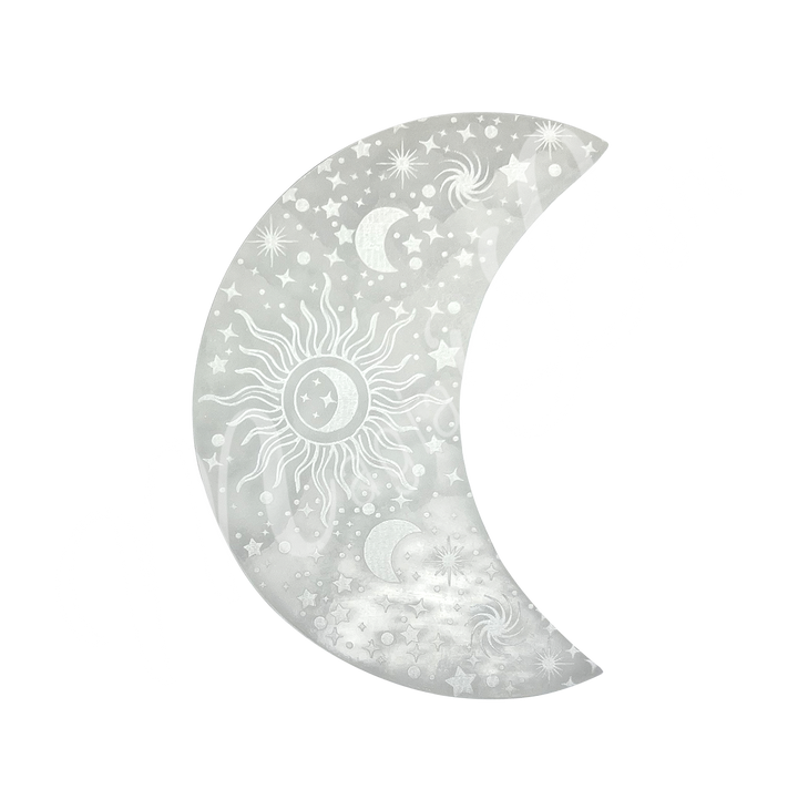 A moon-shaped Selenite crystal engraved with stars, crescent moons, a central sun, and spiral galaxy designs.