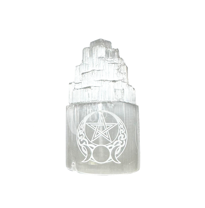 Selenite iceberg carving with black rubber feet. The lamp is engraved with a white triple moon and a pentacle.