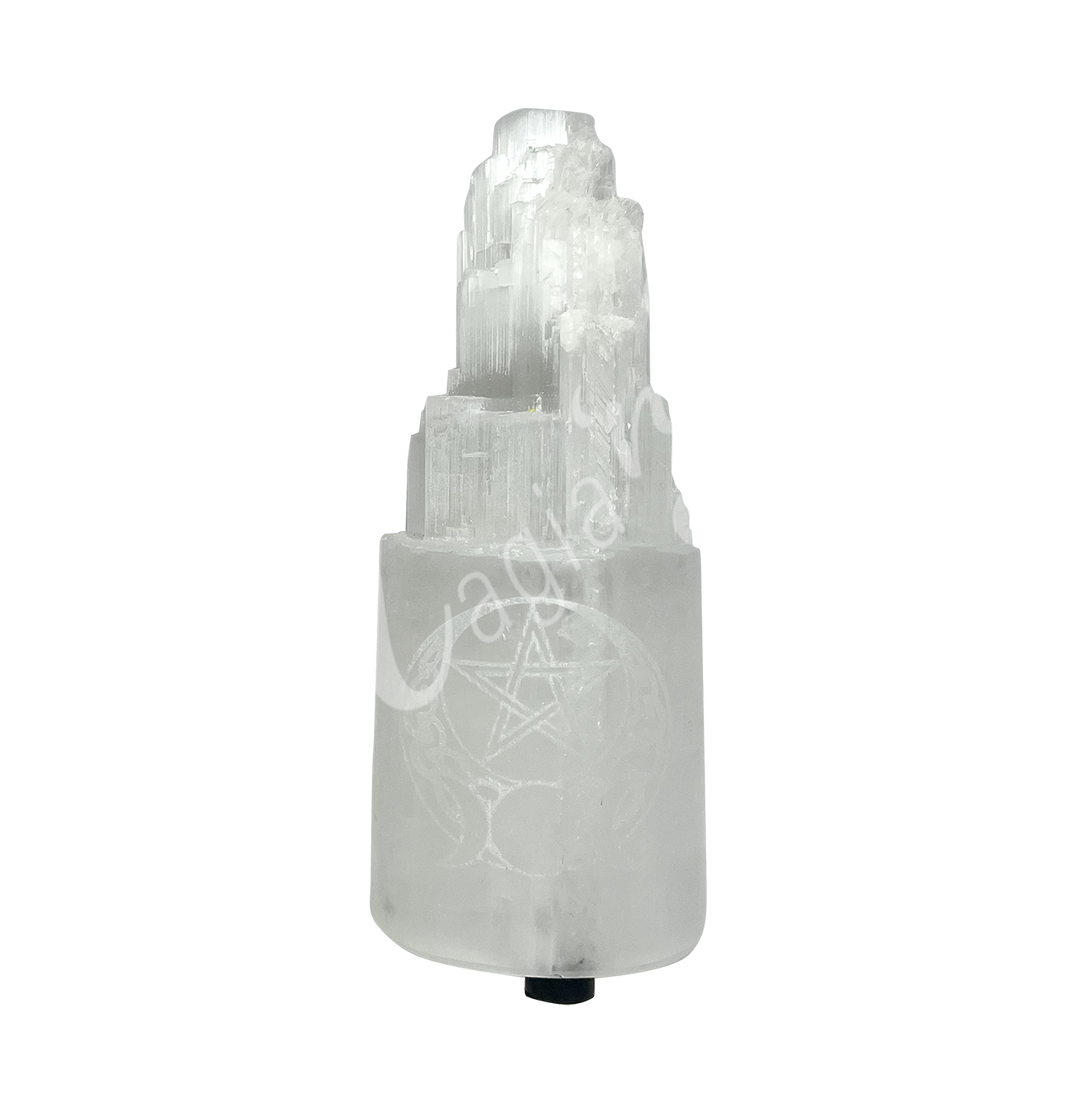 Selenite iceberg carving with black rubber feet. The lamp is engraved with a white triple moon and a pentacle.