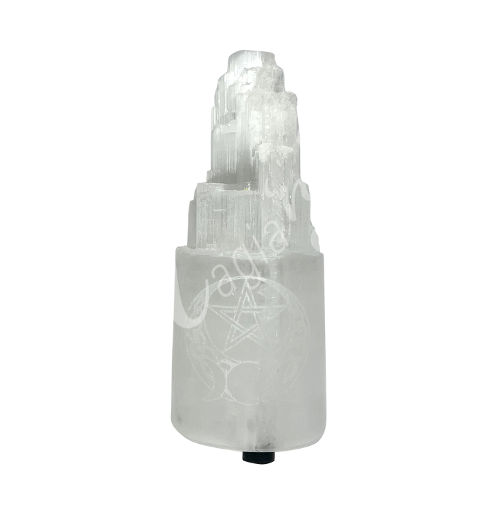 Selenite iceberg carving with black rubber feet. The lamp is engraved with a white triple moon and a pentacle.