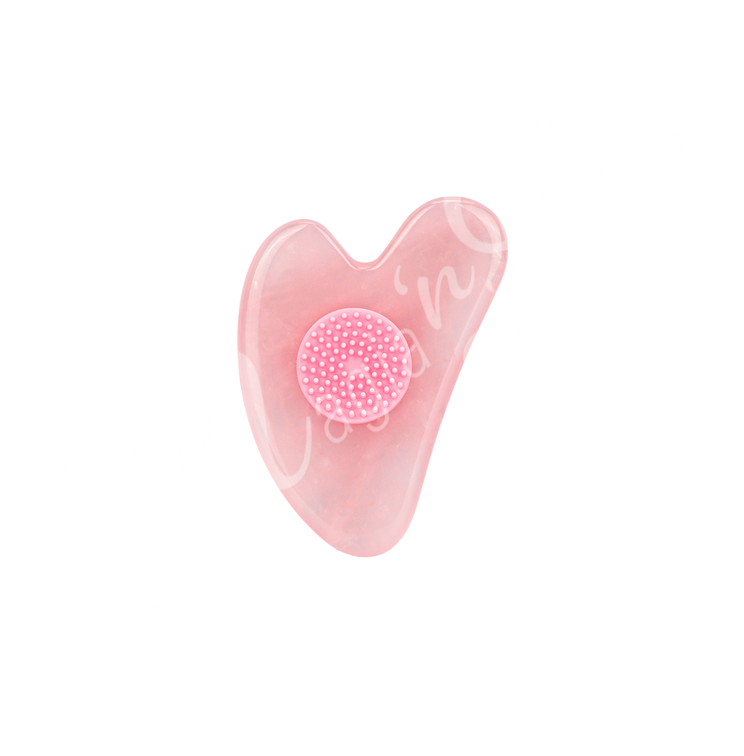 Rose Quartz heart-shaped gua sha with a textured circular grip in the center, designed for facial massage and skincare.