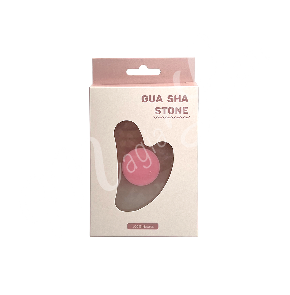 Rose Quartz gua sha stone in retail packaging labeled “Gua Sha Stone,” with a heart-shaped cutout revealing the product inside and “100% Natural” printed at the bottom.