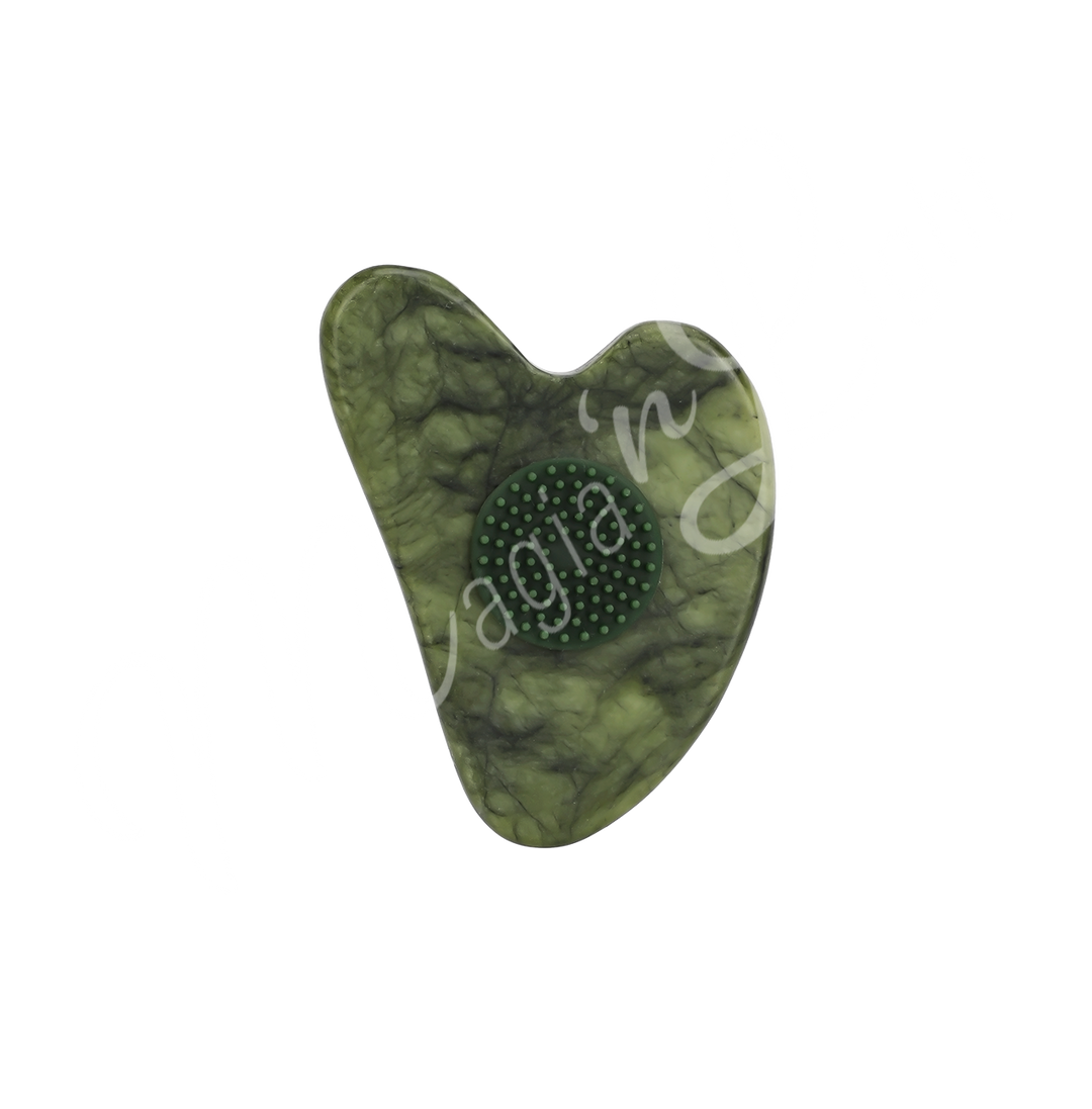 Jade heart-shaped gua sha with a textured circular grip in the center, designed for facial massage and skincare.