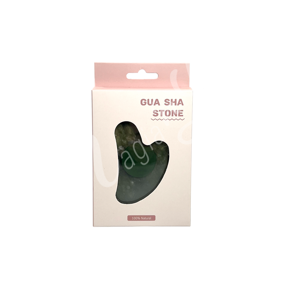 Jade gua sha stone in retail packaging labeled “Gua Sha Stone,” with a heart-shaped cutout revealing the product inside and “100% Natural” printed at the bottom.
