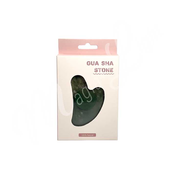 Jade gua sha stone in retail packaging labeled “Gua Sha Stone,” with a heart-shaped cutout revealing the product inside and “100% Natural” printed at the bottom.