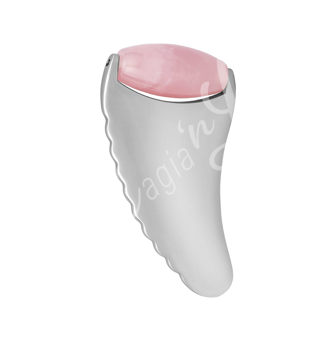 Dual-material gua sha massage tool with a silver metallic body featuring a ridged edge and a smooth Rose Quartz top.