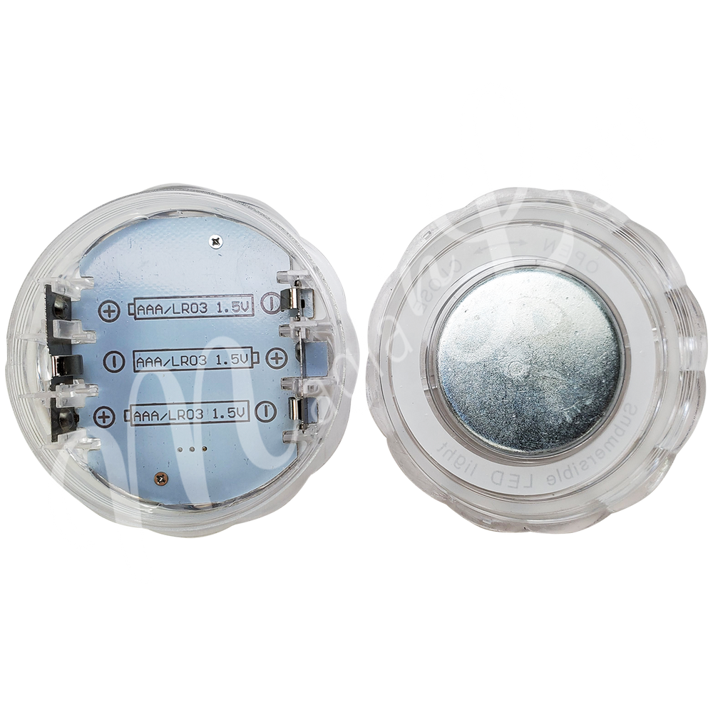 Acrylic round LED light seen from the inside with 3 empty battery slots.