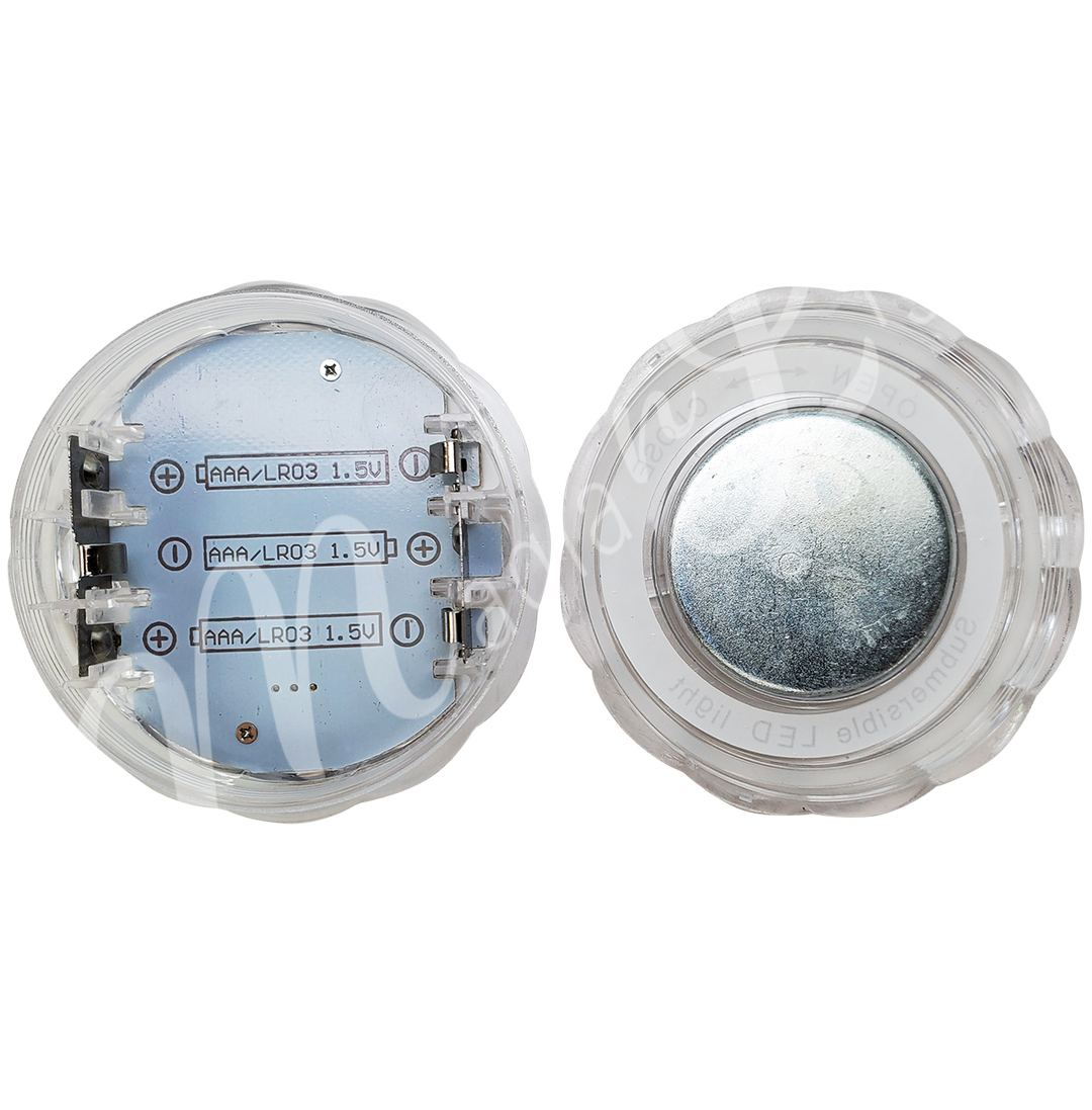 Acrylic round LED light seen from the inside with 3 empty battery slots.