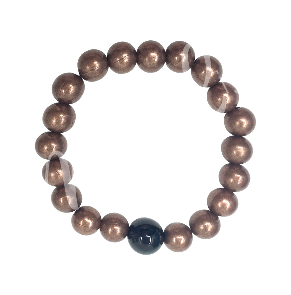 A bracelet made of copper beads, accented with a single black tourmaline bead.
