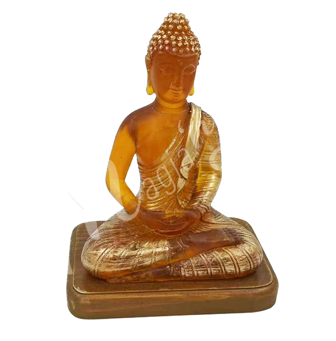 A resin lamp and statue representing the deity Buddha in meditation, set on a wooden base.