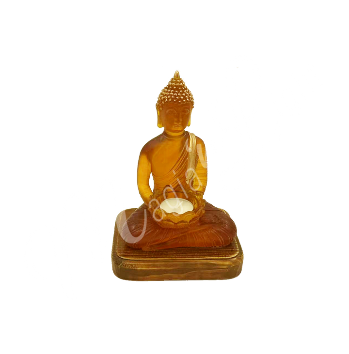A resin lamp and statue representing the deity Buddha, holding a lotus flower in her hands, set on a rectangular wooden base. The lotus flower serves as a tealight holder.