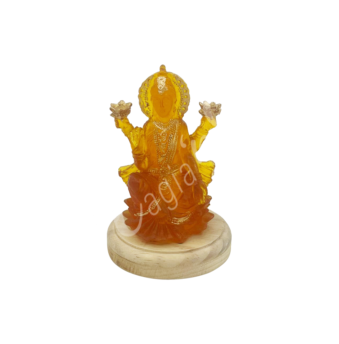 A resin lamp and statue representing the deity Lakshmi, set on a round wooden base.