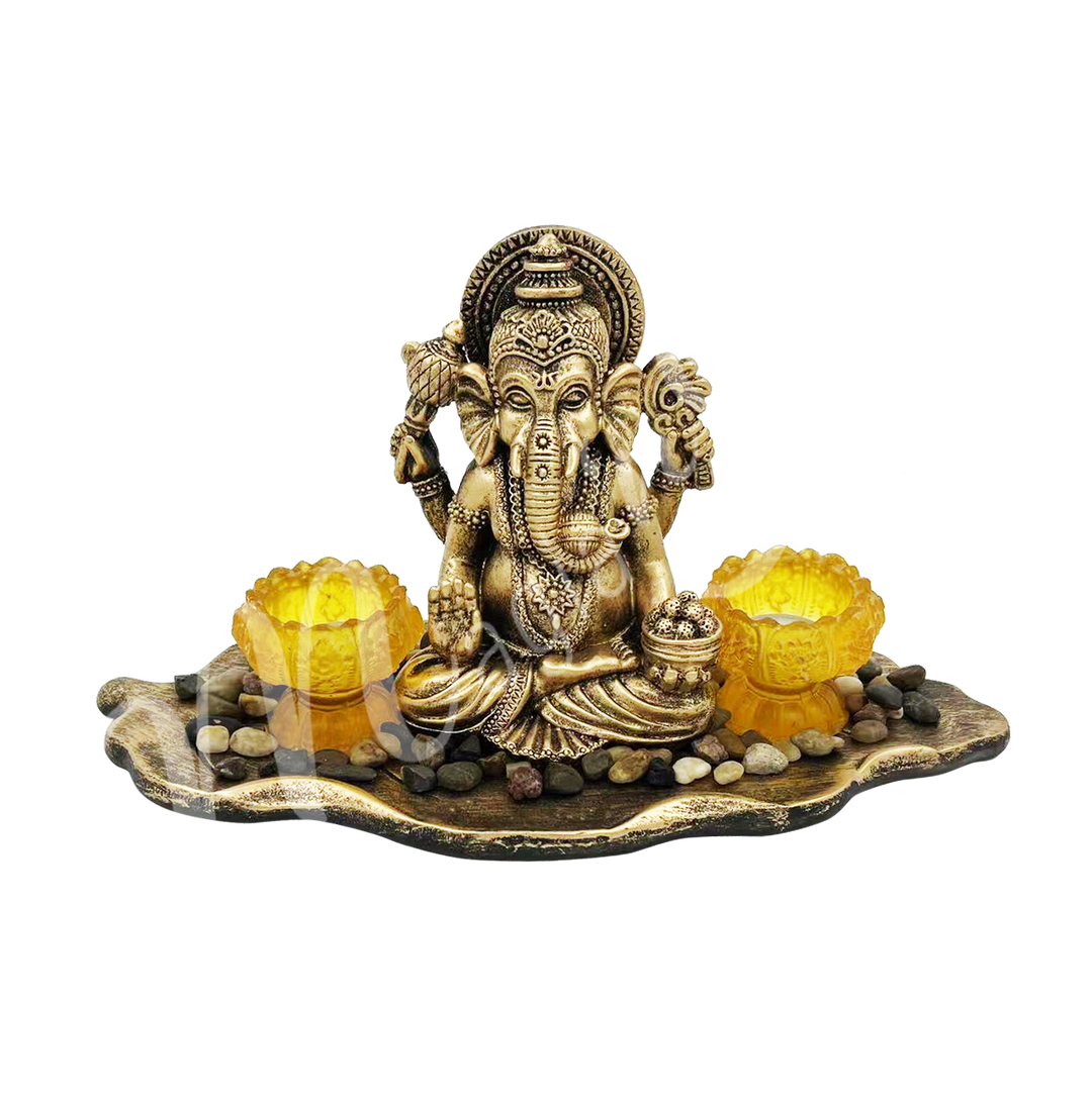 A resin tealight holder featuring the deity Ganesha seated within a leaf design, with two tealight spaces placed beside him