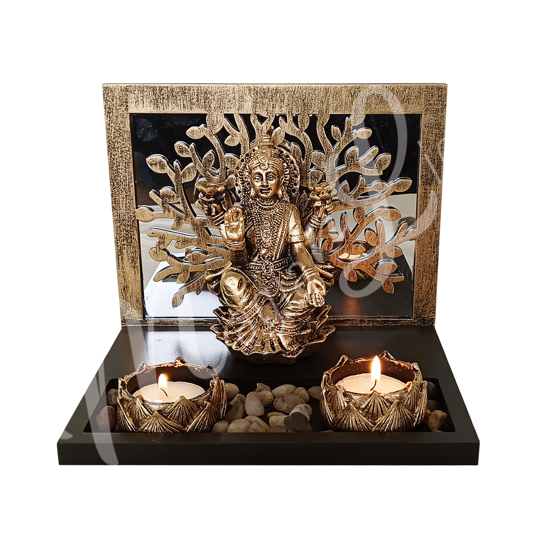 A resin tealight holder featuring the deity Lakshmi seated before a Tree of Life, with two tealight spaces at the front.