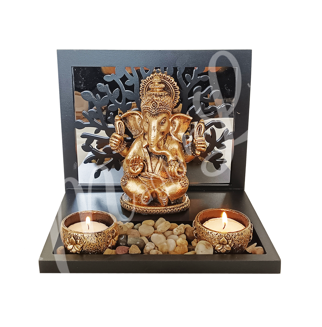 A resin tealight holder featuring the deity Ganesha seated before a Tree of Life, with two tealight spaces at the front.
