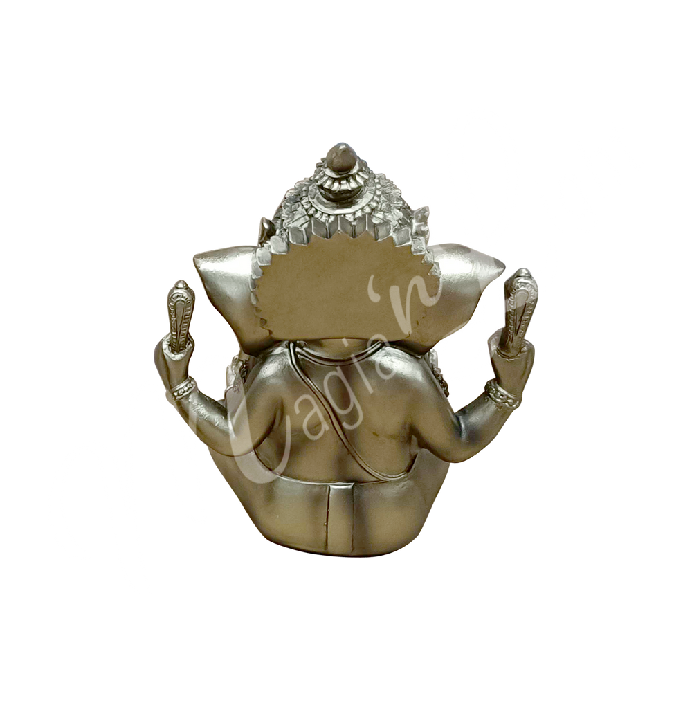 A gold-colored resin statue featuring the deity Ganesha seated, seen from the back.