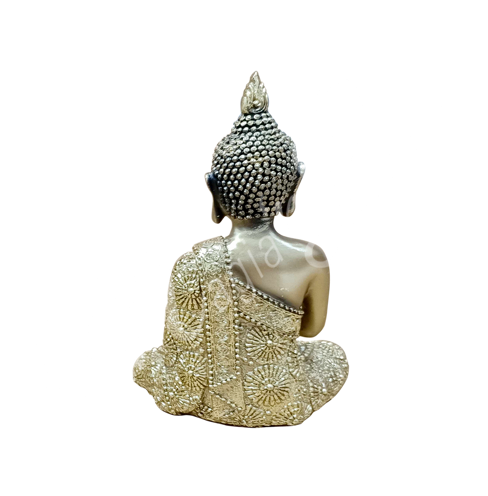 An antique gold-colored resin statue featuring a seated Buddha in prayer, seen from the back.