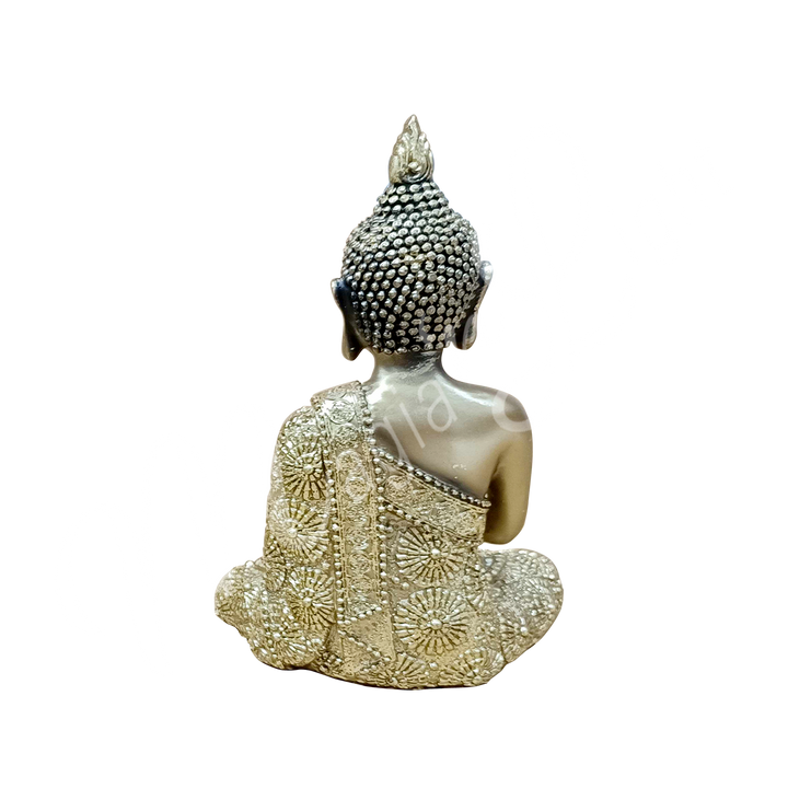 An antique gold-colored resin statue featuring a seated Buddha in prayer, seen from the back.