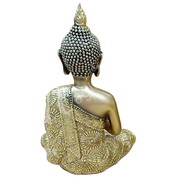 A gold-colored resin statue featuring a seated Buddha in prayer, seen from the back.