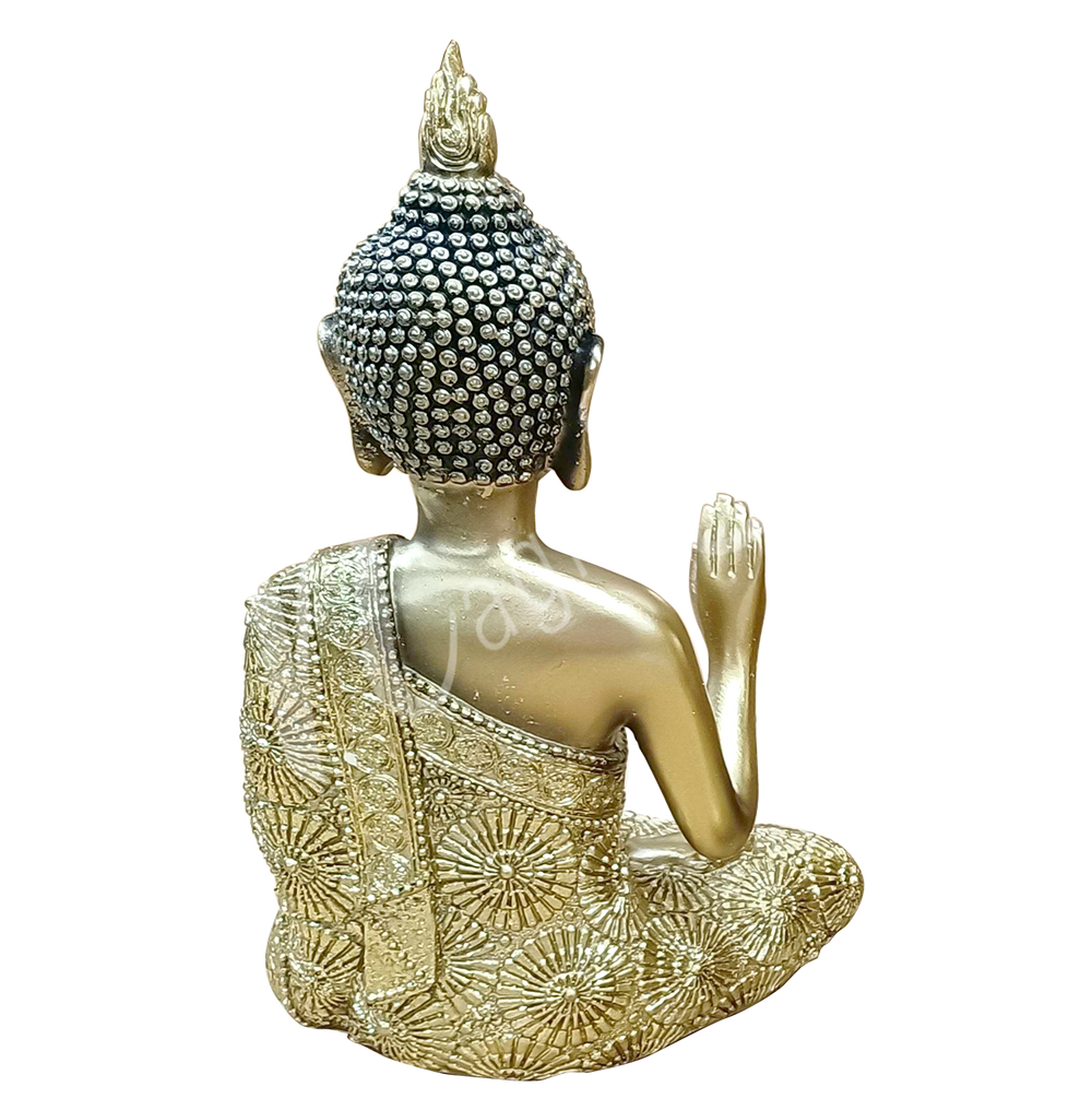 An antique gold-colored resin statue featuring a seated Buddha with a raised hand, seen from the back.
