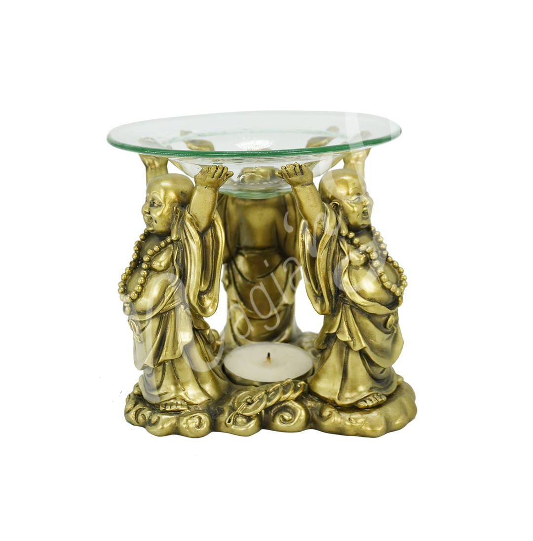 Decorative gold-tone oil burner featuring three Buddha with prayer beads holding up a round glass dish, with space for a tealight candle at the base.