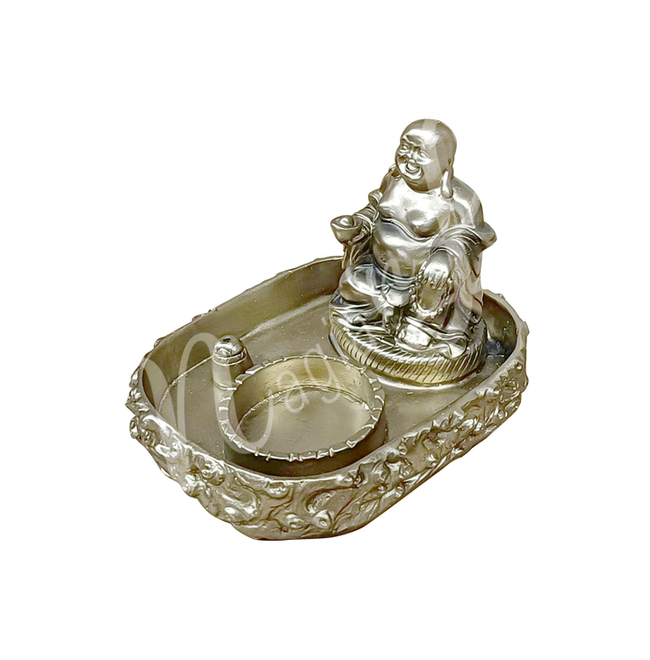 A rectangular gold-colored tealight and incense holder made of resin, featuring a happy Buddha with tealight and incense spaces at the front, shown at an angle.