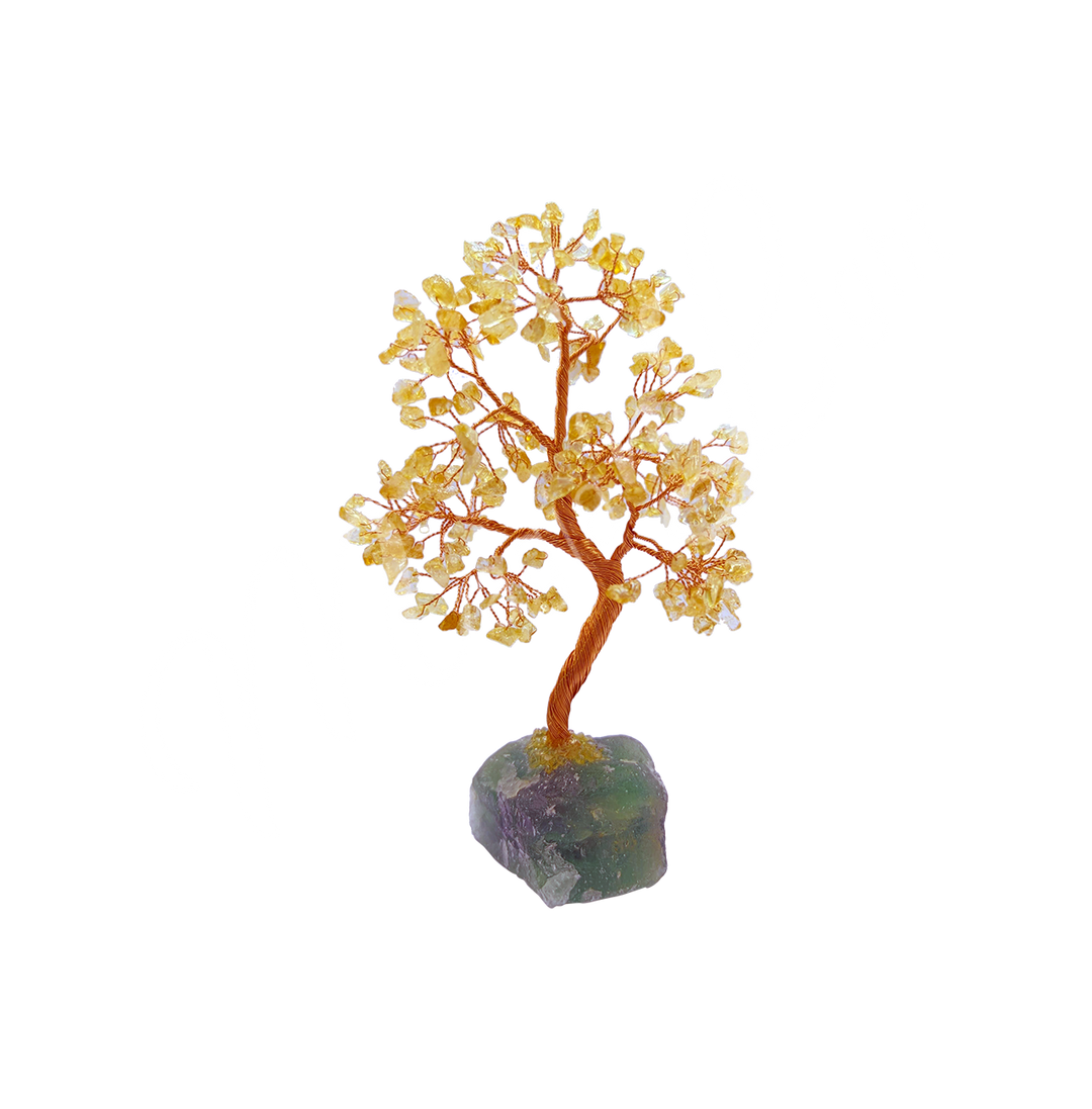 A wire gemstone bonsai tree with citrine crystal chips, mounted on a natural fluorite base.