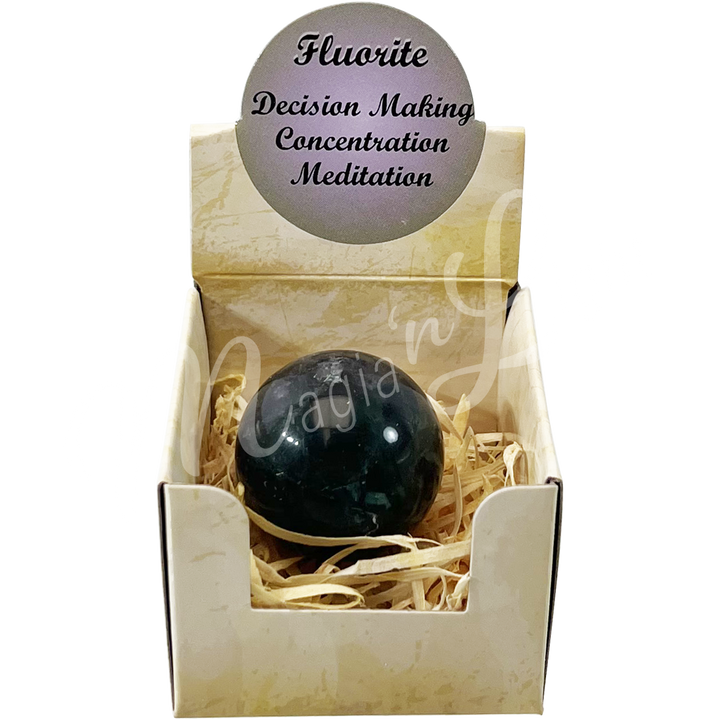 A open gift box with the words "Fluorite, Decision Making, Concentration, Meditation", showing a Fluorite sphere stone.