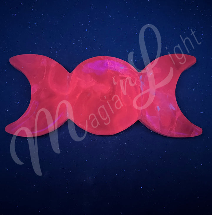 Polished Pink Calcite crystal plate shaped like a Triple Moon, seen under UV light.