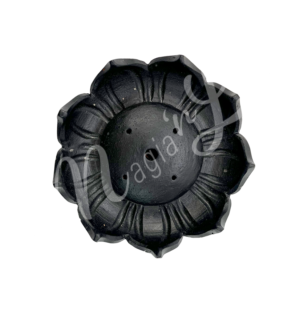 A black ceramic incense holder shaped like a lotus flower, seen from the above.