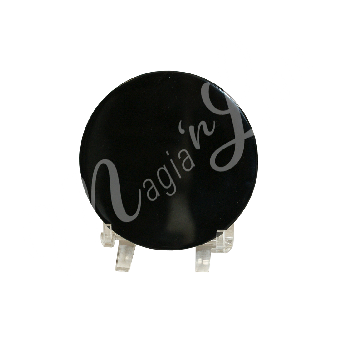 a round Scrying mirror made from obsidian, seen on a stand.
