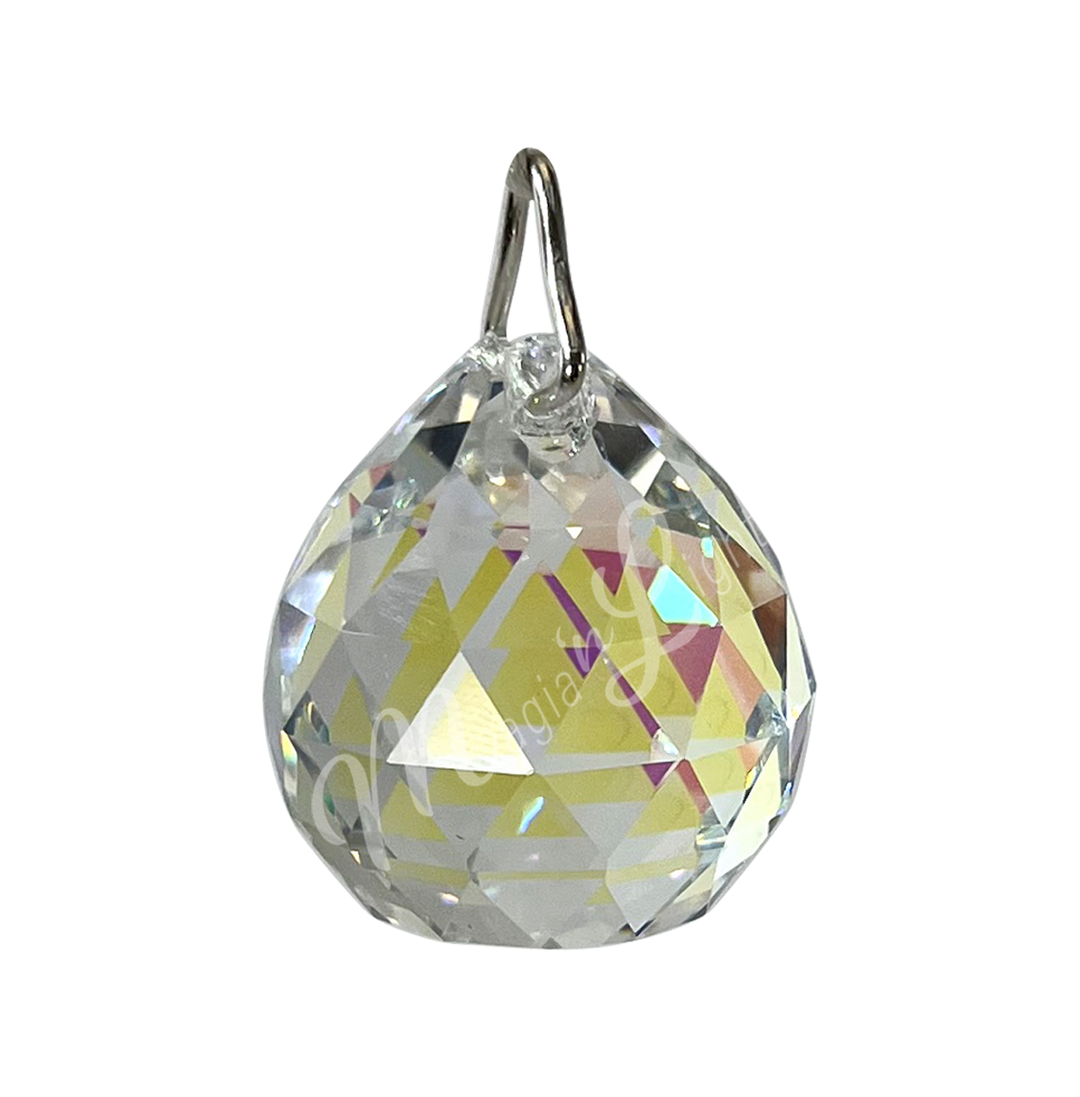 Faceted clear crystal ball prism with a teardrop shape, reflecting light and rainbow light.