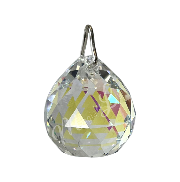 Faceted clear crystal ball prism with a teardrop shape, reflecting light and rainbow light.