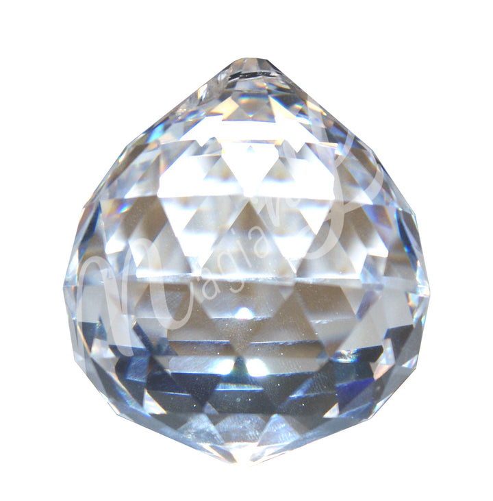Faceted clear crystal ball prism with a teardrop shape, reflecting light and rainbow colors.