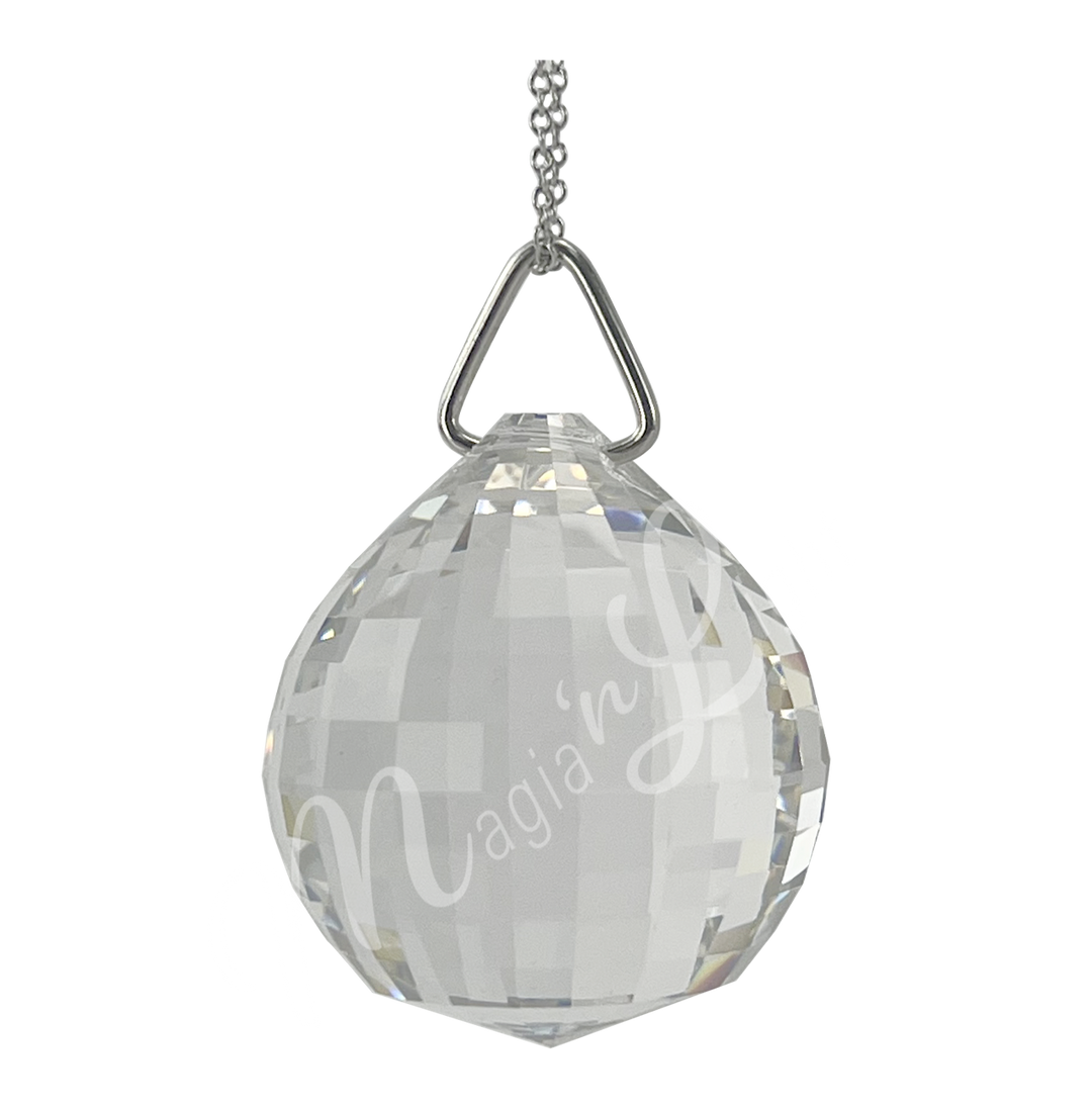 Faceted clear crystal ball prism with a disco ball shape, reflecting light and rainbow colors.