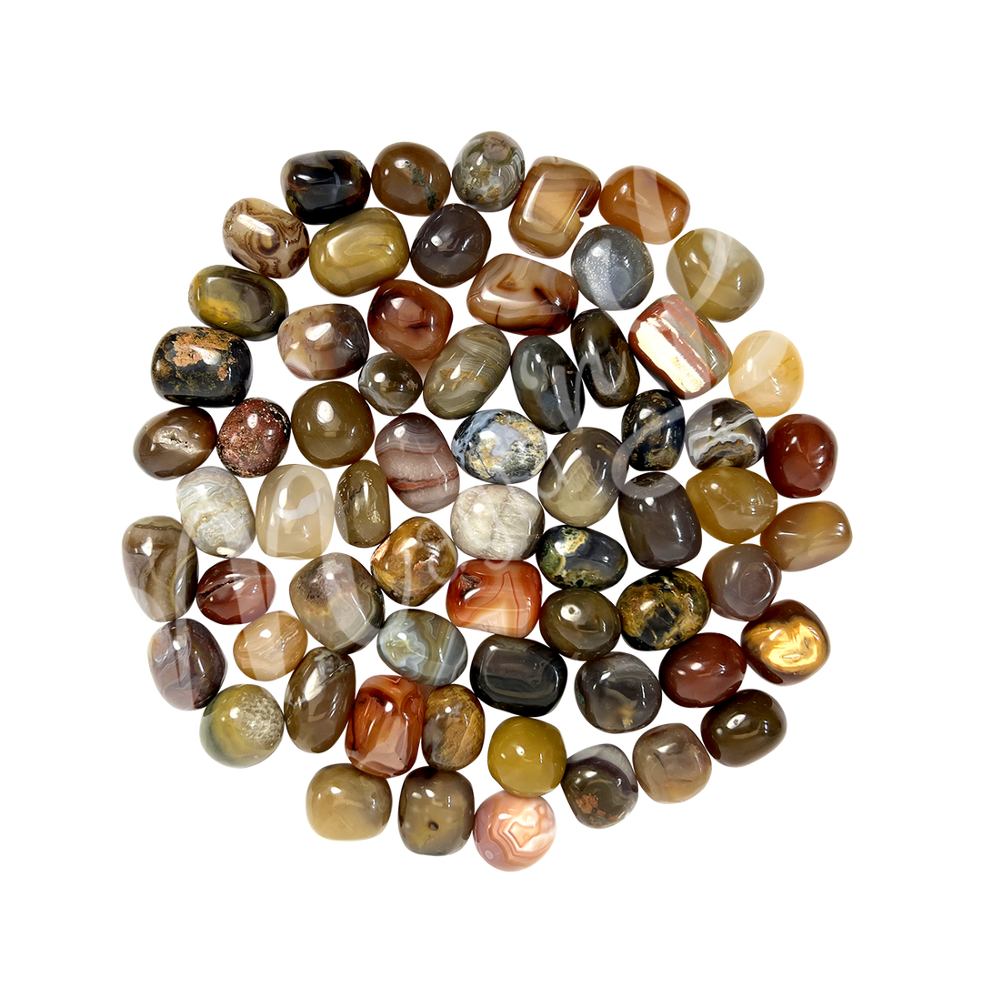 Collection of polished tumbled stones in shades of orange, yellow and brown, arranged together in a circular pile.