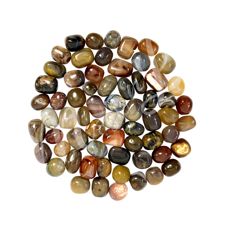 Collection of polished tumbled stones in shades of orange, yellow and brown, arranged together in a circular pile.
