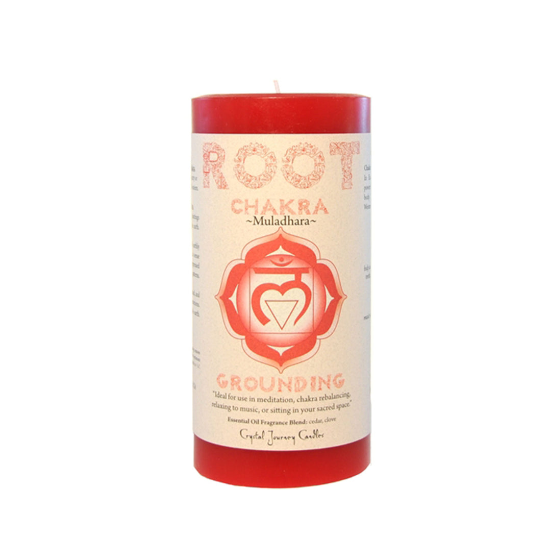 A red pillar candle labeled 'ROOT CHAKRA GROUNDING' with a graphic of a chakra symbol.