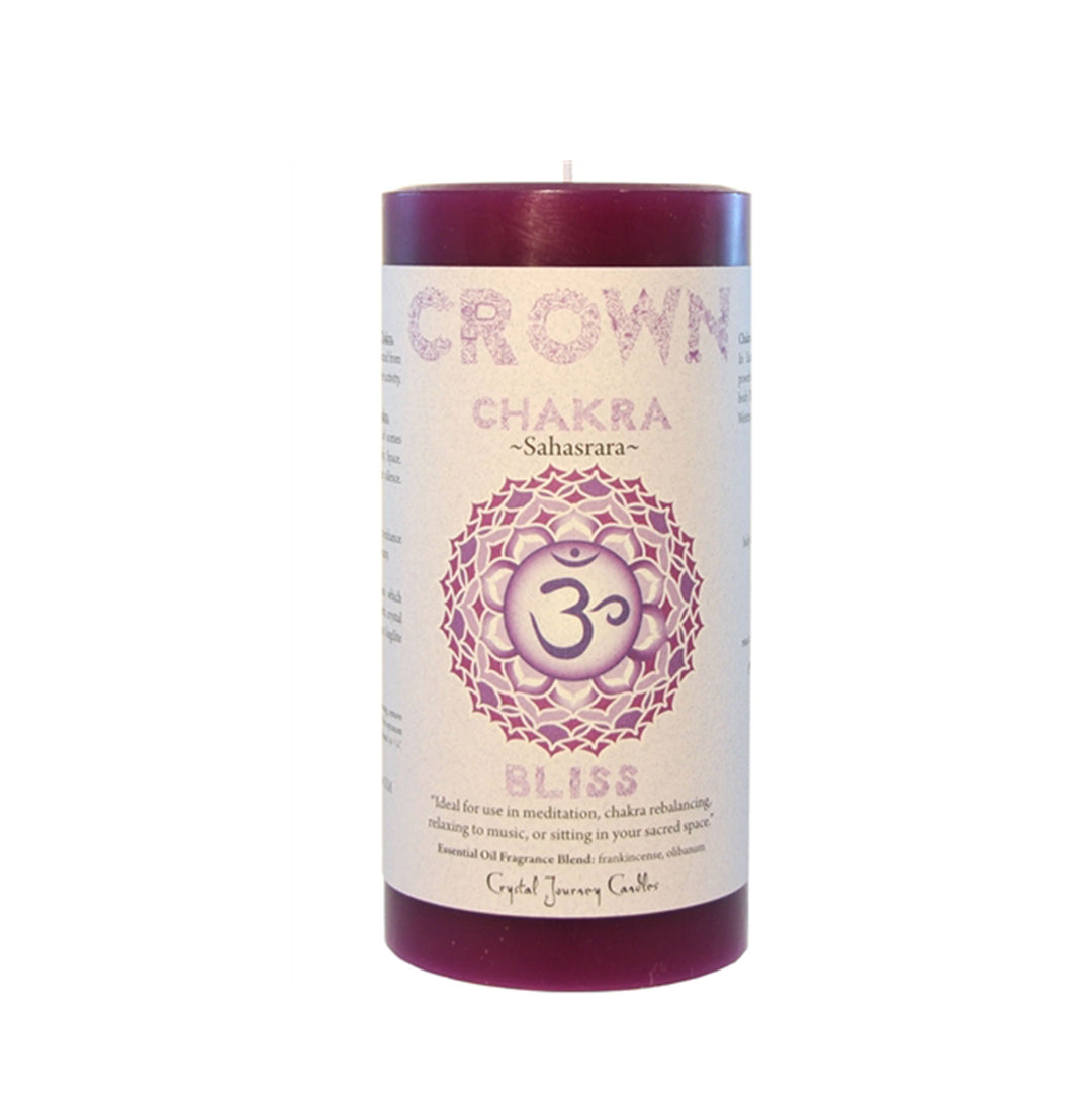 A red pillar candle labeled 'CROWN CHAKRA BLISS' with a graphic of a chakra symbol and text detailing the intended use for meditation and relaxation.