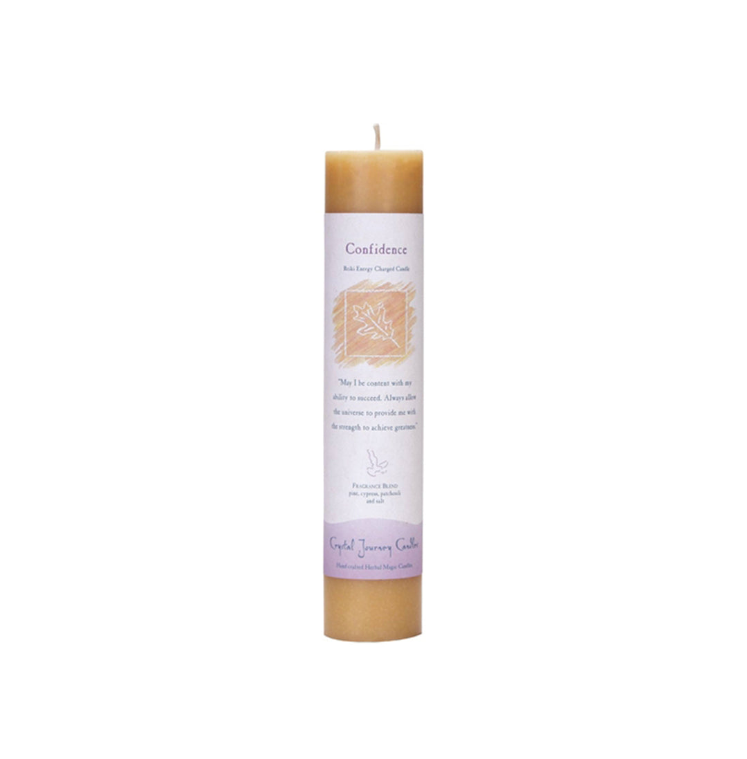 A beige pillar candle with a label showing the candle's name and the benefits it provides, such as 'Confidence'.